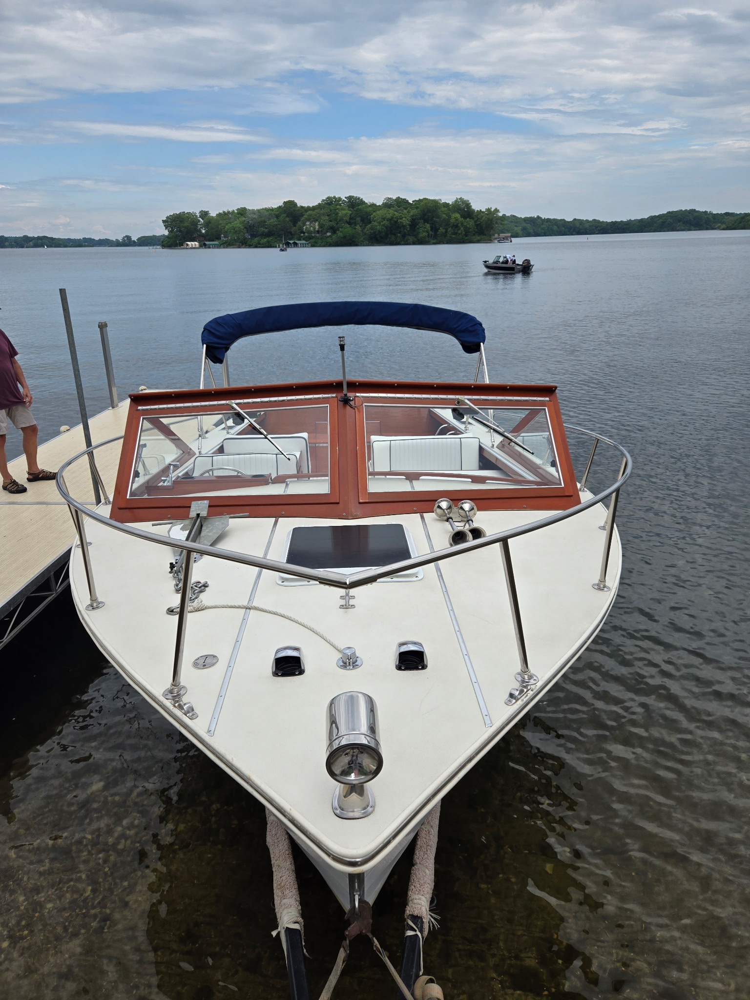 Skiff Craft Hardtop — covered helm and windshield, moored at dock on a calm lake.