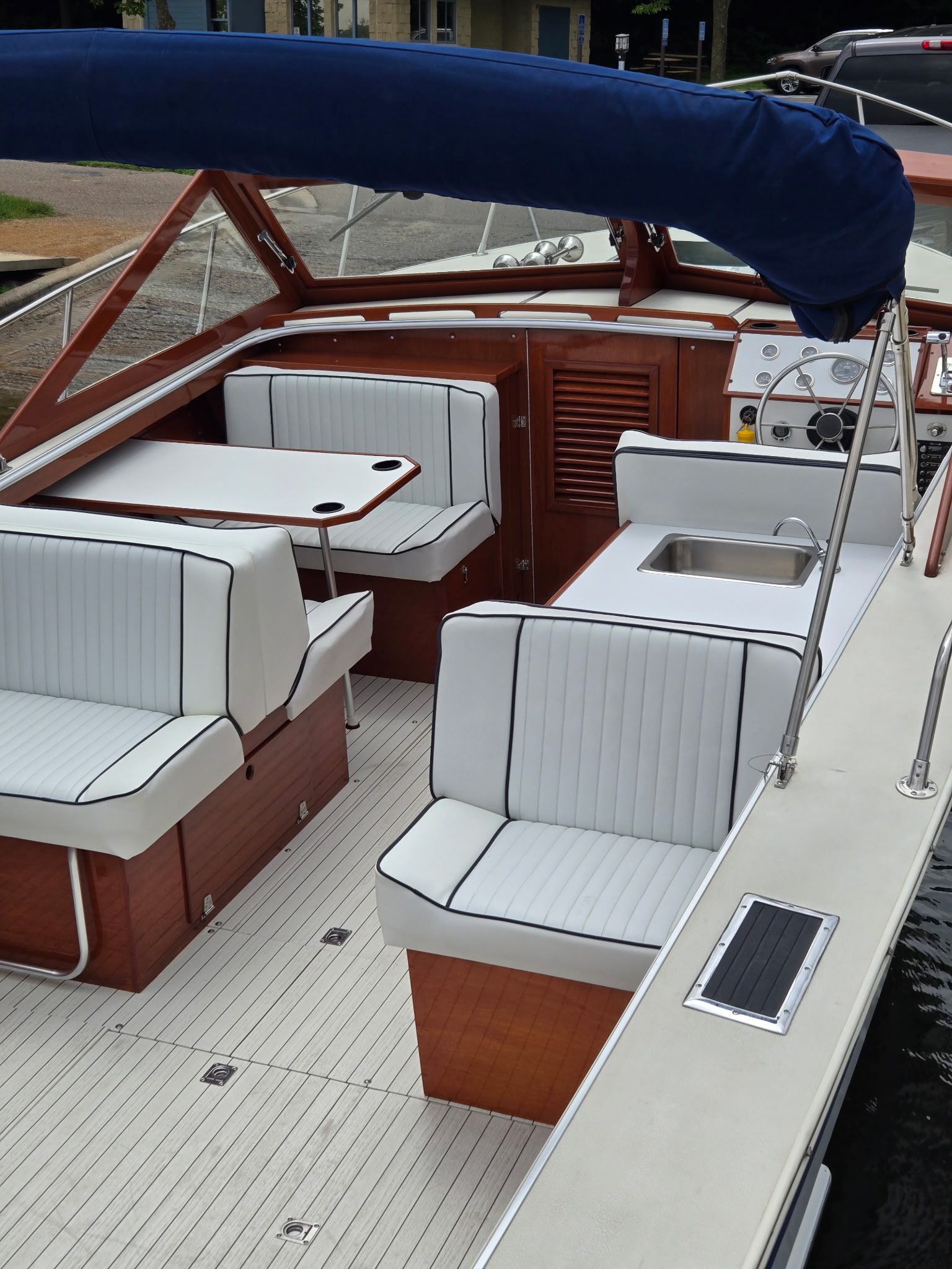 Skiff Craft interior — white pleated upholstery and mahogany cabinetry.