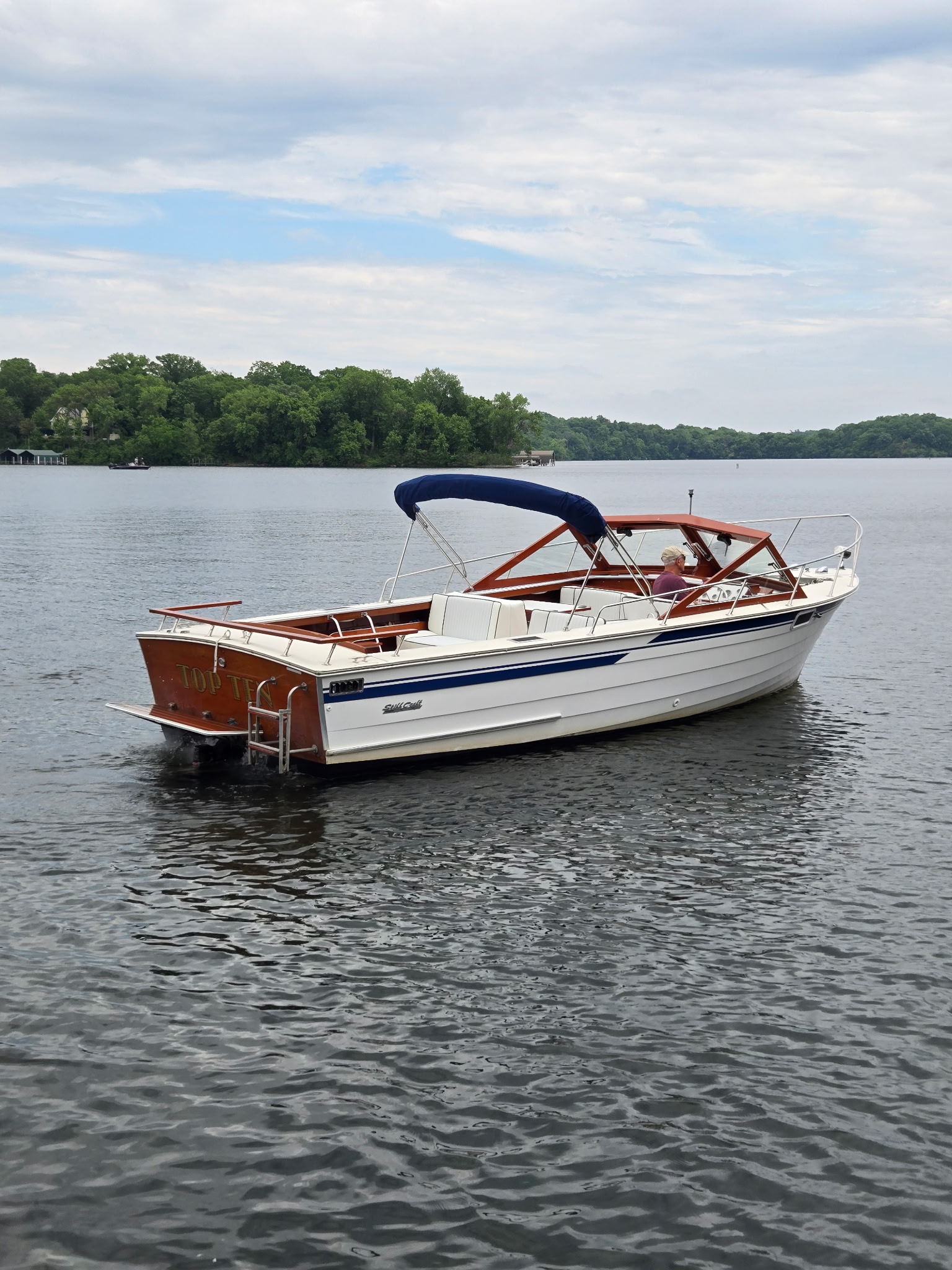 Skiff Craft full exterior on a calm Minnesota lake, summer day.